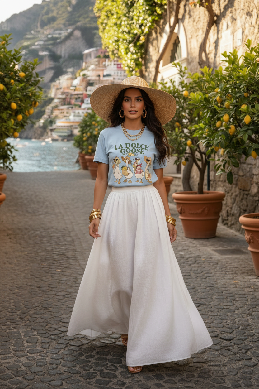 Woman in a scenic location wearing a 'La Dolce Vita' t-shirt and white skirt.